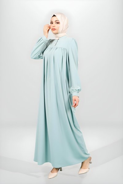 فستان محتشم بقصّة الكورساج لون نعناعي بأساور مزررة